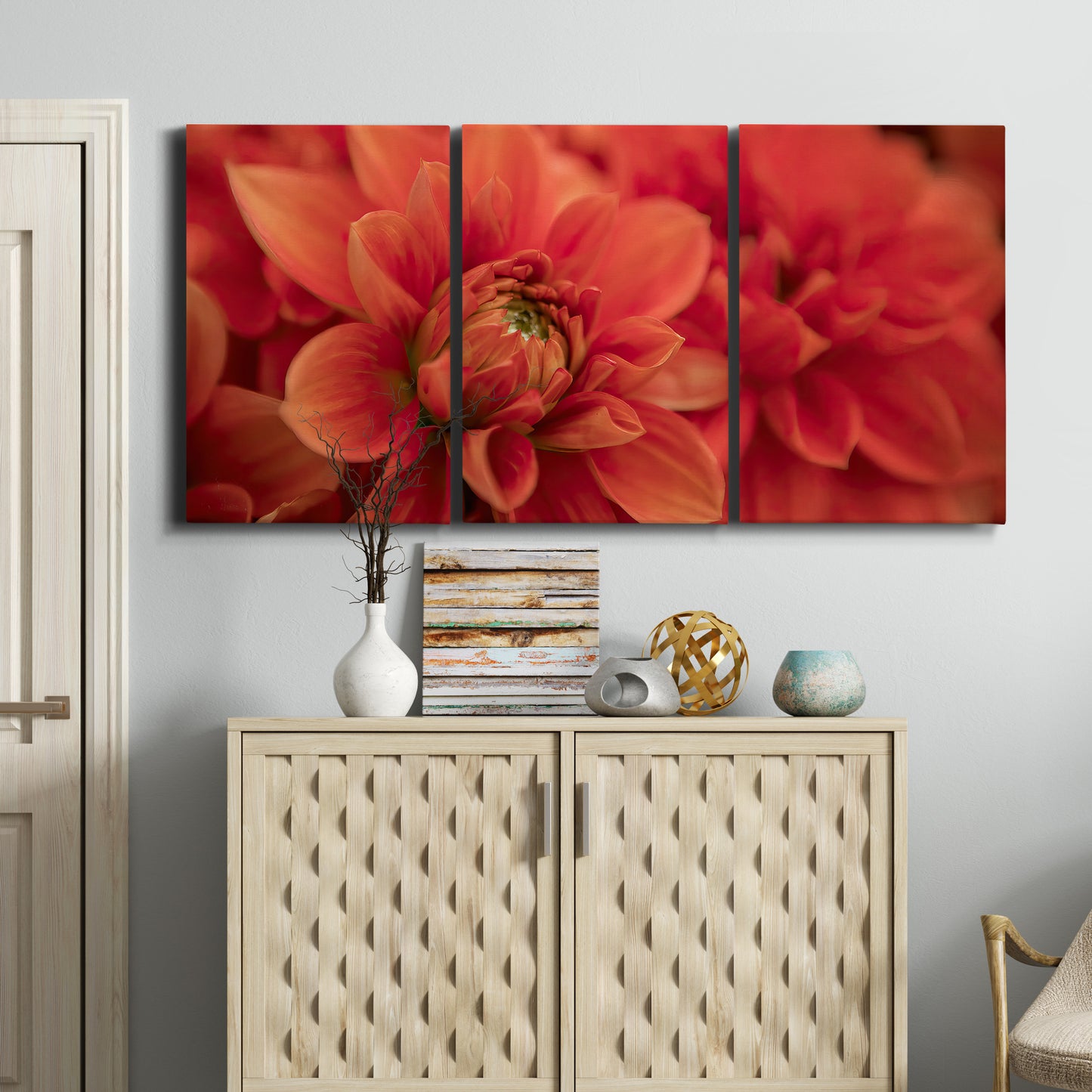 Three-panel canvas wall art featuring vivid red floral close up, displayed above a cabinet in an entryway.