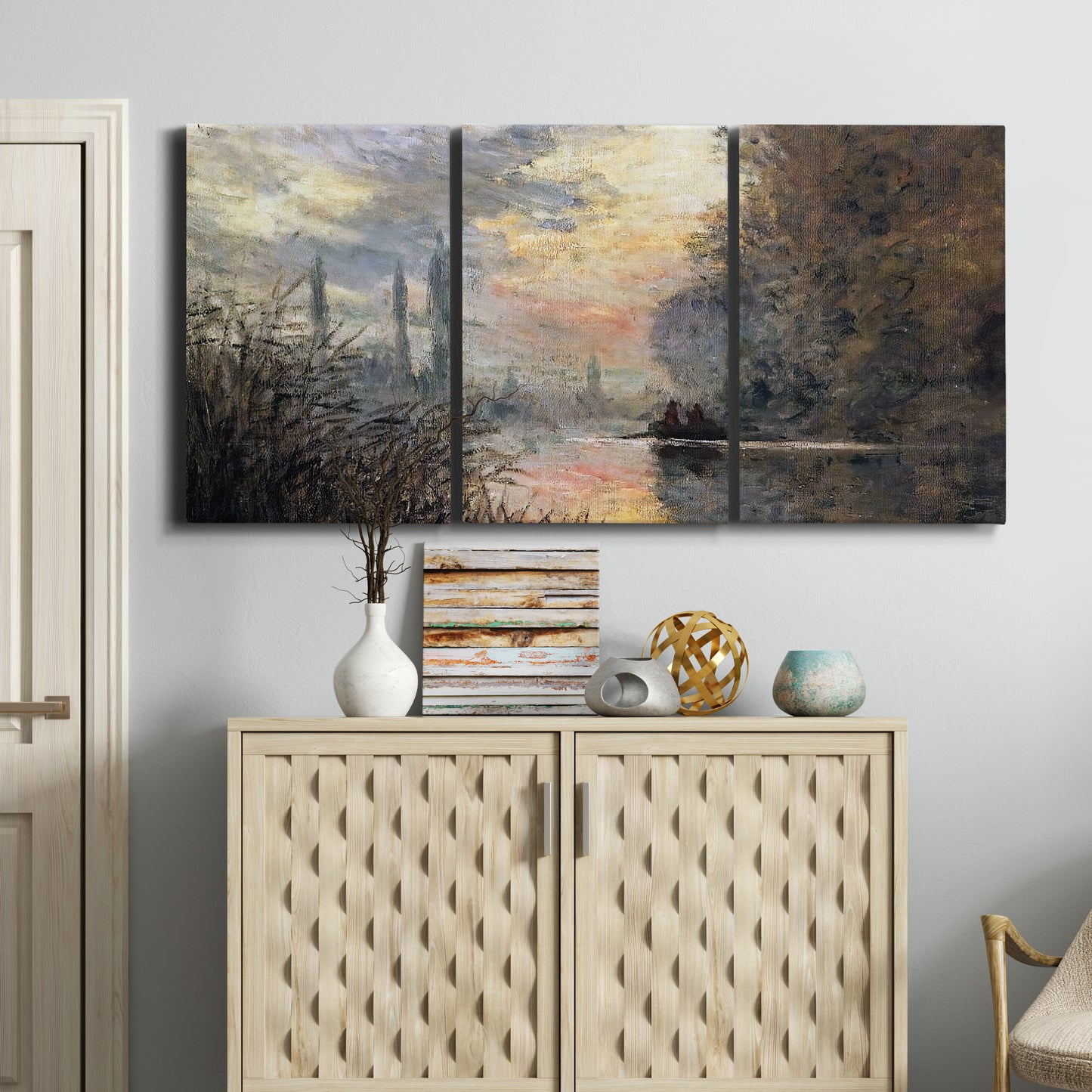 Three-panel canvas wall art featuring winter river sunset with reflections, displayed above a cabinet in an entryway.