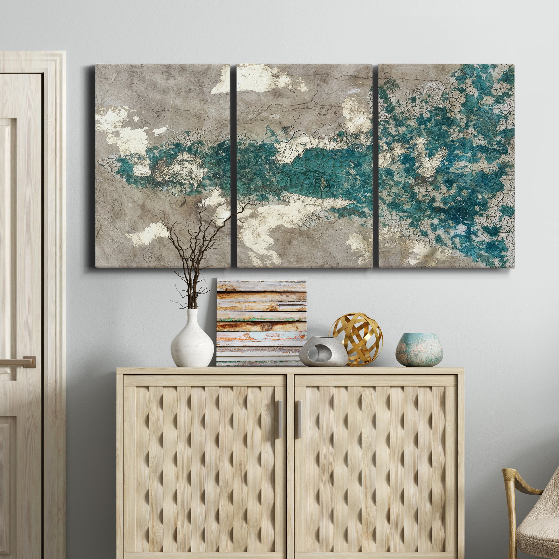 Three-panel canvas wall art featuring layered mineral abstract textures, displayed above a cabinet in an entryway.