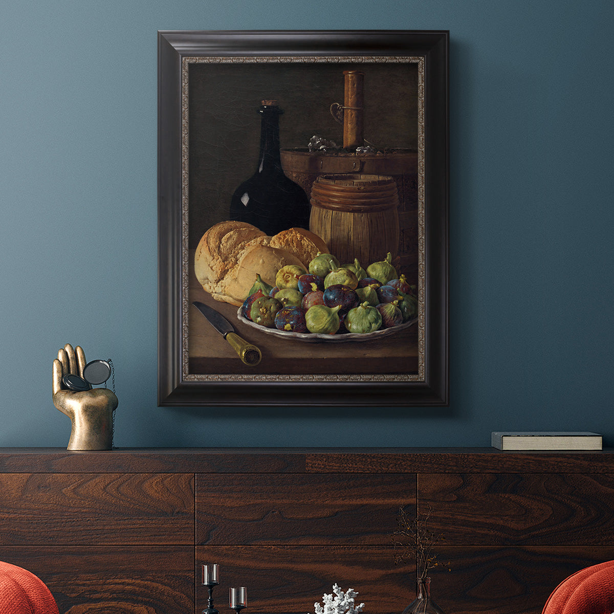Realist still life with figs and bread by Luis Meléndez in an ornate black frame with gilded inner detail displayed in a dark-toned interior setting.