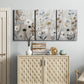 Three-panel canvas wall art featuring misty wildflower meadow landscape, displayed above a cabinet in an entryway.