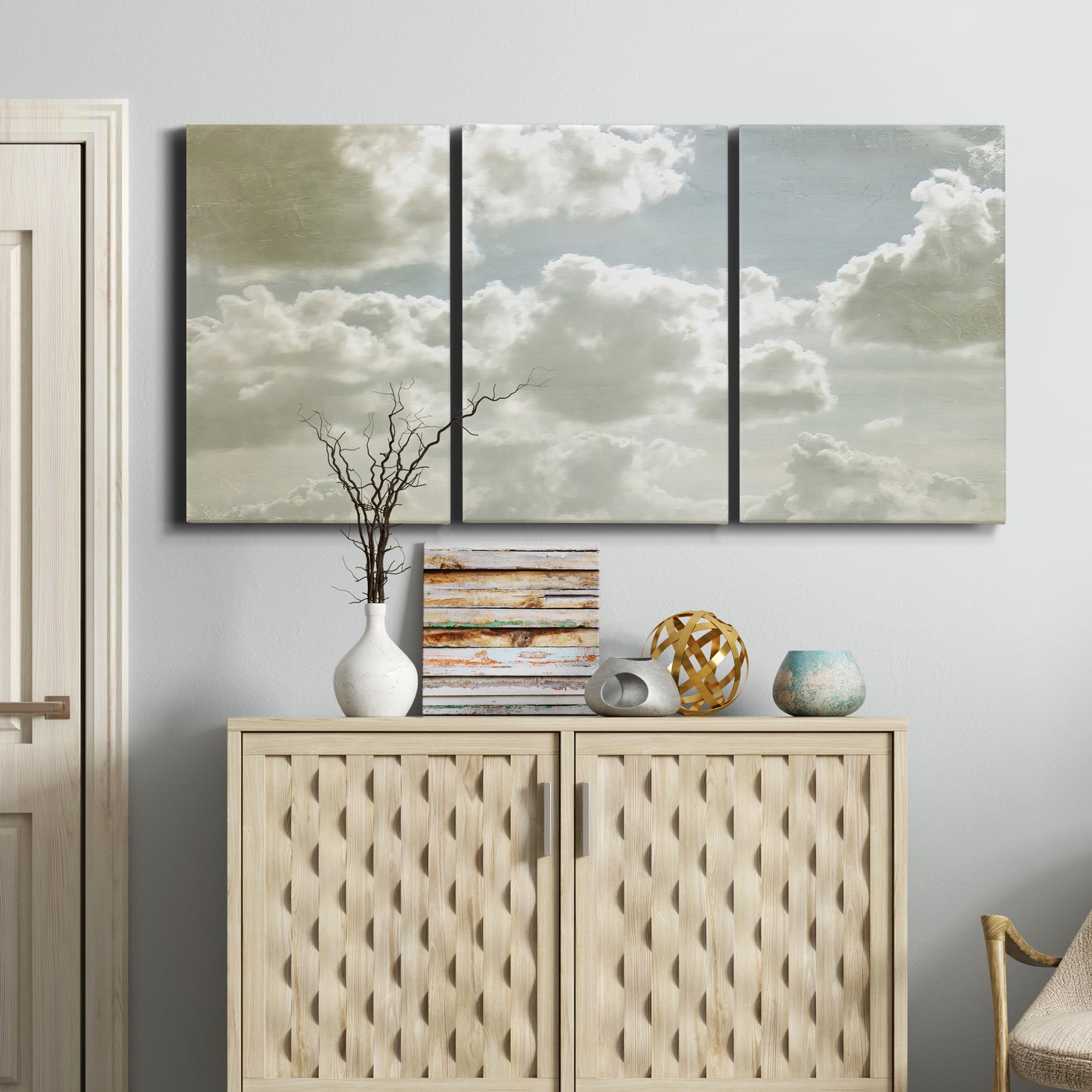Three-panel canvas wall art featuring whimsical vertical tree landscape, displayed above a cabinet in an entryway.