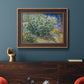 Impressionist lilac flower painting by Vincent van Gogh in an ornate bronzed mahogany wood frame displayed in a dark-toned interior setting.