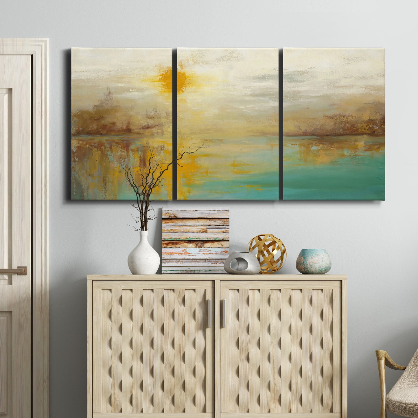 Three-panel canvas wall art featuring warm abstract end of summer palette, displayed above a cabinet in an entryway.