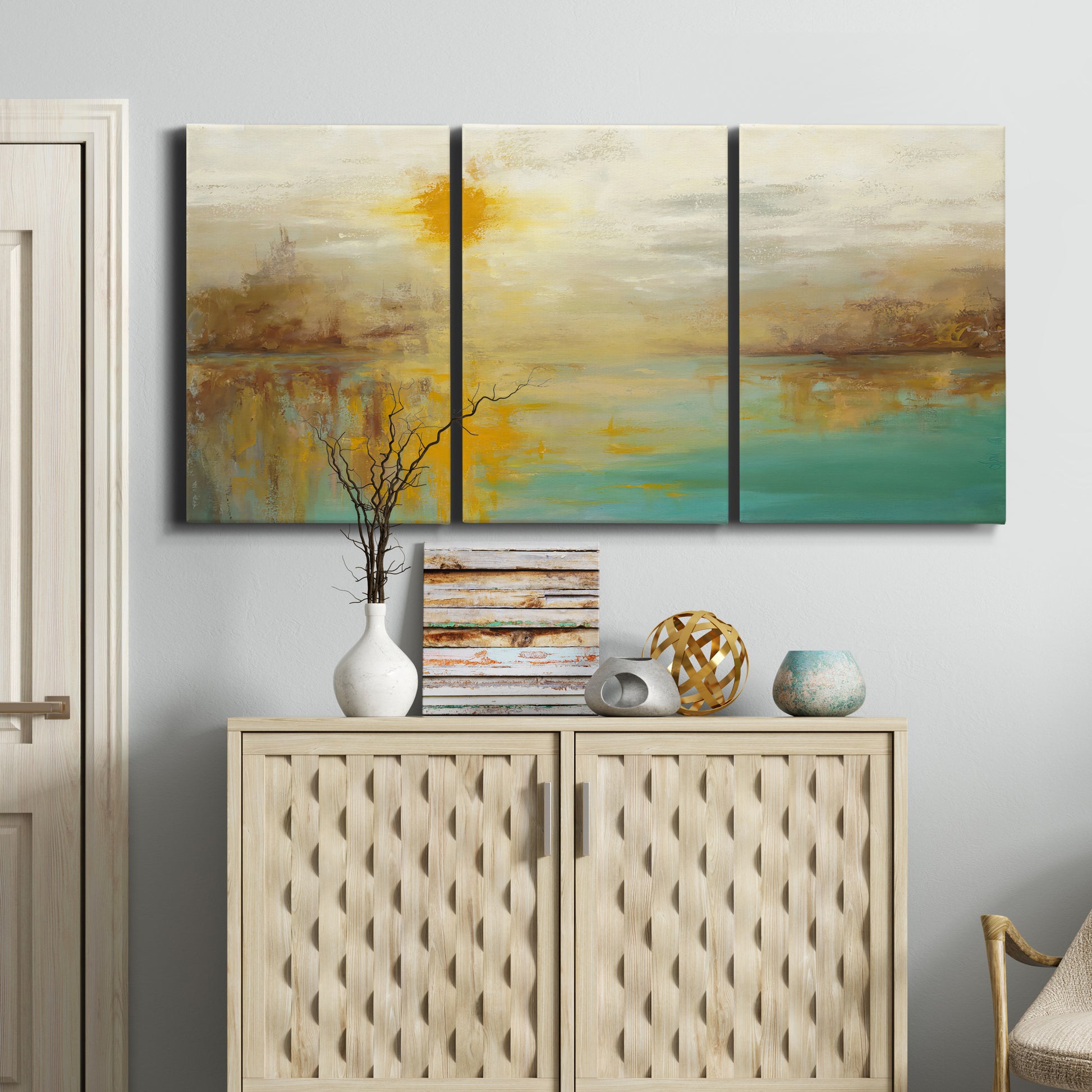 Three-panel canvas wall art featuring warm abstract end of summer palette, displayed above a cabinet in an entryway.