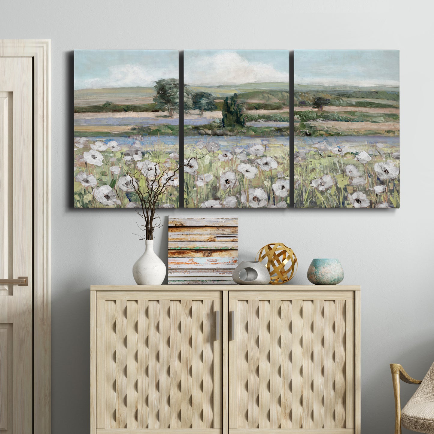 Three-panel canvas wall art featuring vintage poppy filled valley, displayed above a cabinet in an entryway.