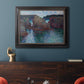 Impressionist rocky seascape by Claude Monet in an ornate black frame with gilded inner detail displayed in a dark-toned interior setting.