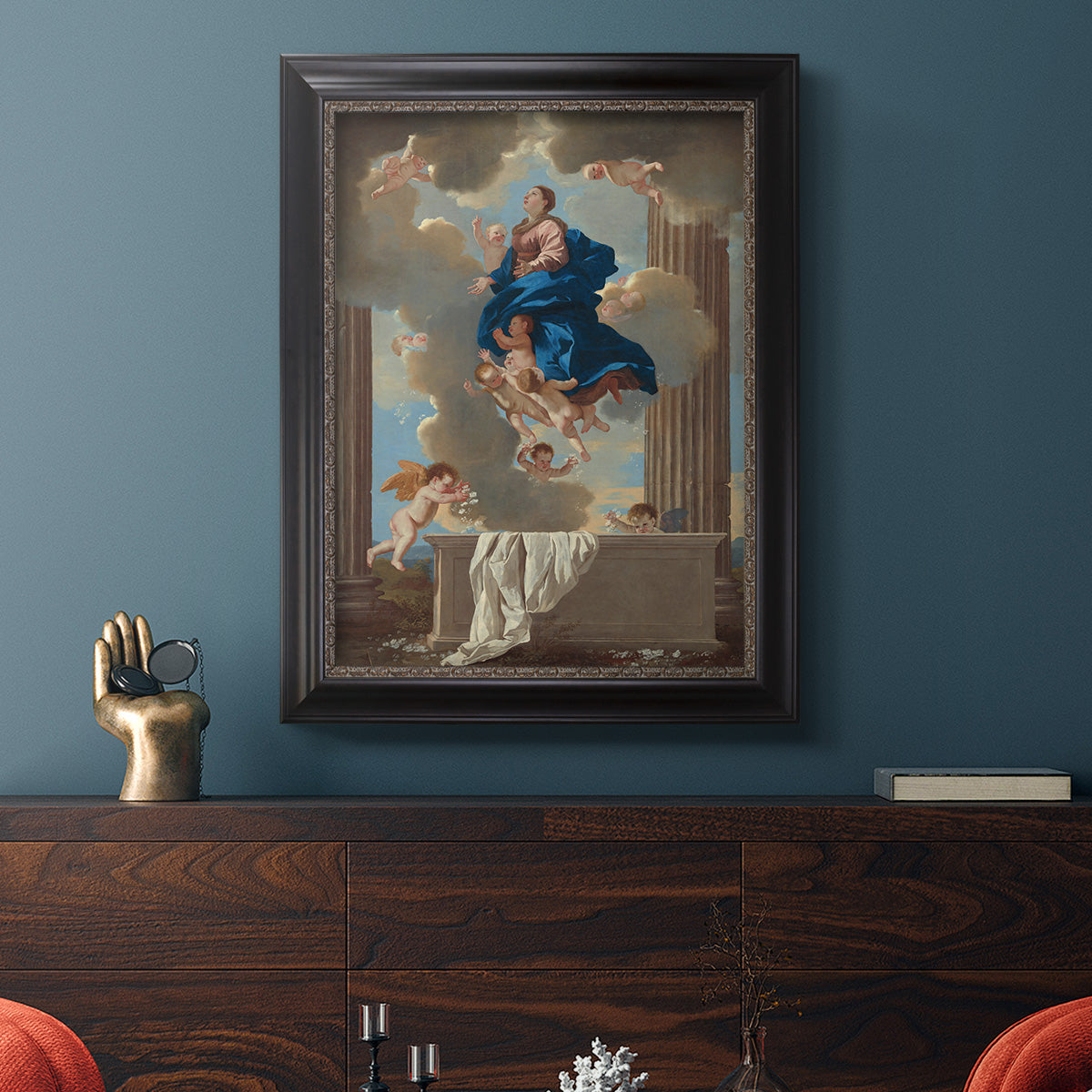 Classical religious depiction of the Assumption of the Virgin by Nicolas Poussin in an ornate black frame with gilded inner detail displayed in a dark-toned interior setting.