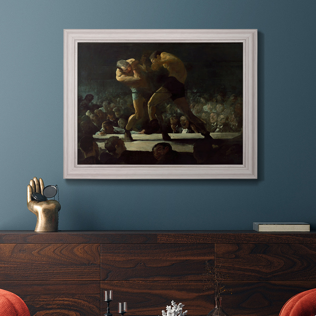 American social club scene painting by George Bellows in an ornate weathered white frame displayed in a dark-toned interior setting.