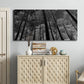 Three-panel canvas wall art featuring riverside houses along canal, displayed above a cabinet in an entryway.