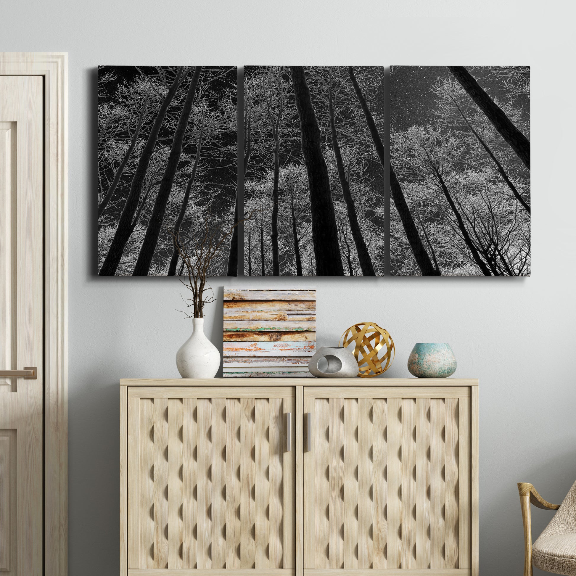 Three-panel canvas wall art featuring riverside houses along canal, displayed above a cabinet in an entryway.