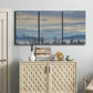 Three-panel canvas wall art featuring misty horizon over quiet landscape, displayed above a cabinet in an entryway.