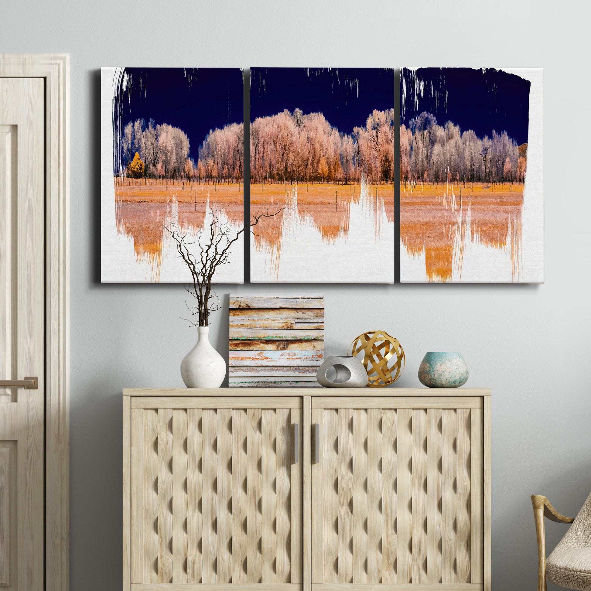Three-panel canvas wall art featuring panoramic treeline landscape photograph, displayed above a cabinet in an entryway.