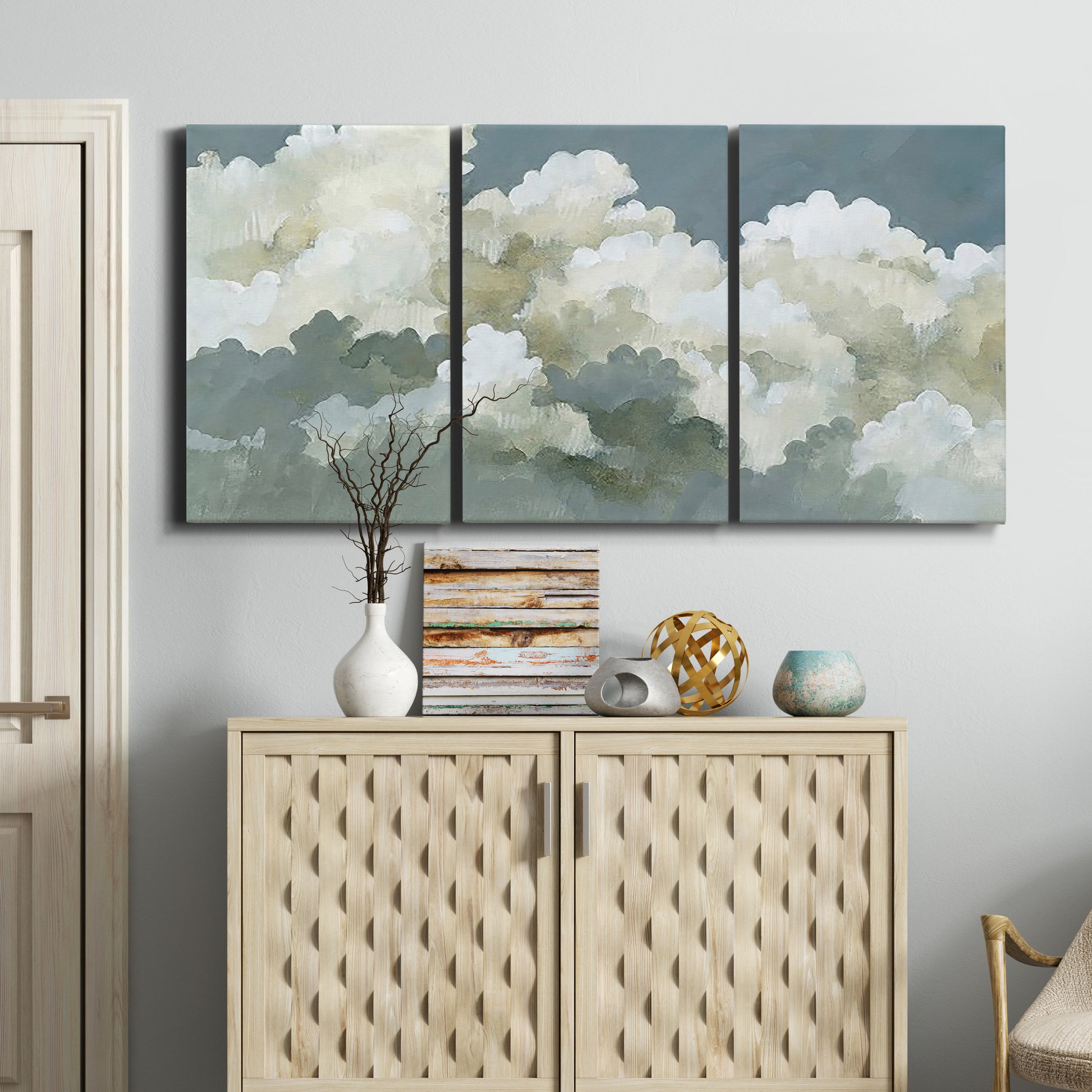 Three-panel canvas wall art featuring abstract evening landscape with depth, displayed above a cabinet in an entryway.