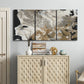 Three-panel canvas wall art featuring pale abstract mask like forms, displayed above a cabinet in an entryway.