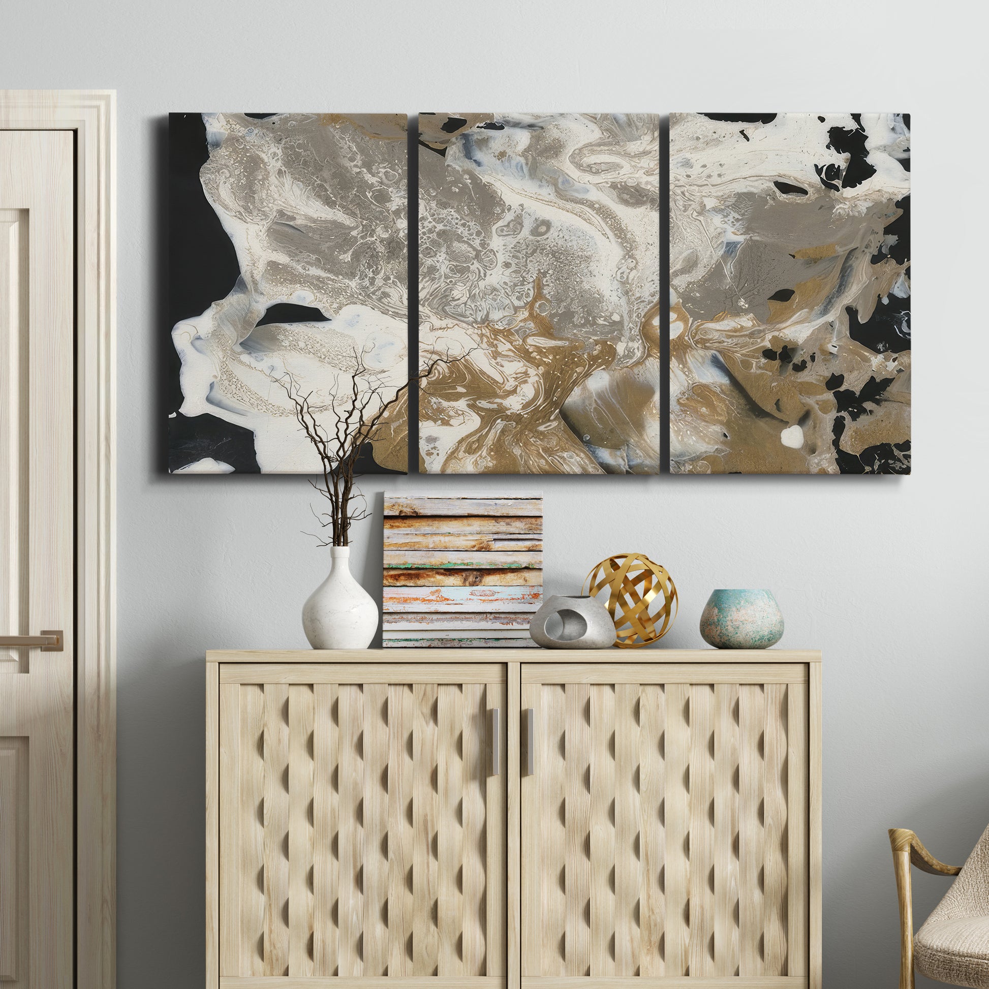 Three-panel canvas wall art featuring pale abstract mask like forms, displayed above a cabinet in an entryway.