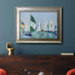 Coastal harbor watercolor painting in an ornate mottled silver frame displayed in a dark-toned interior setting.