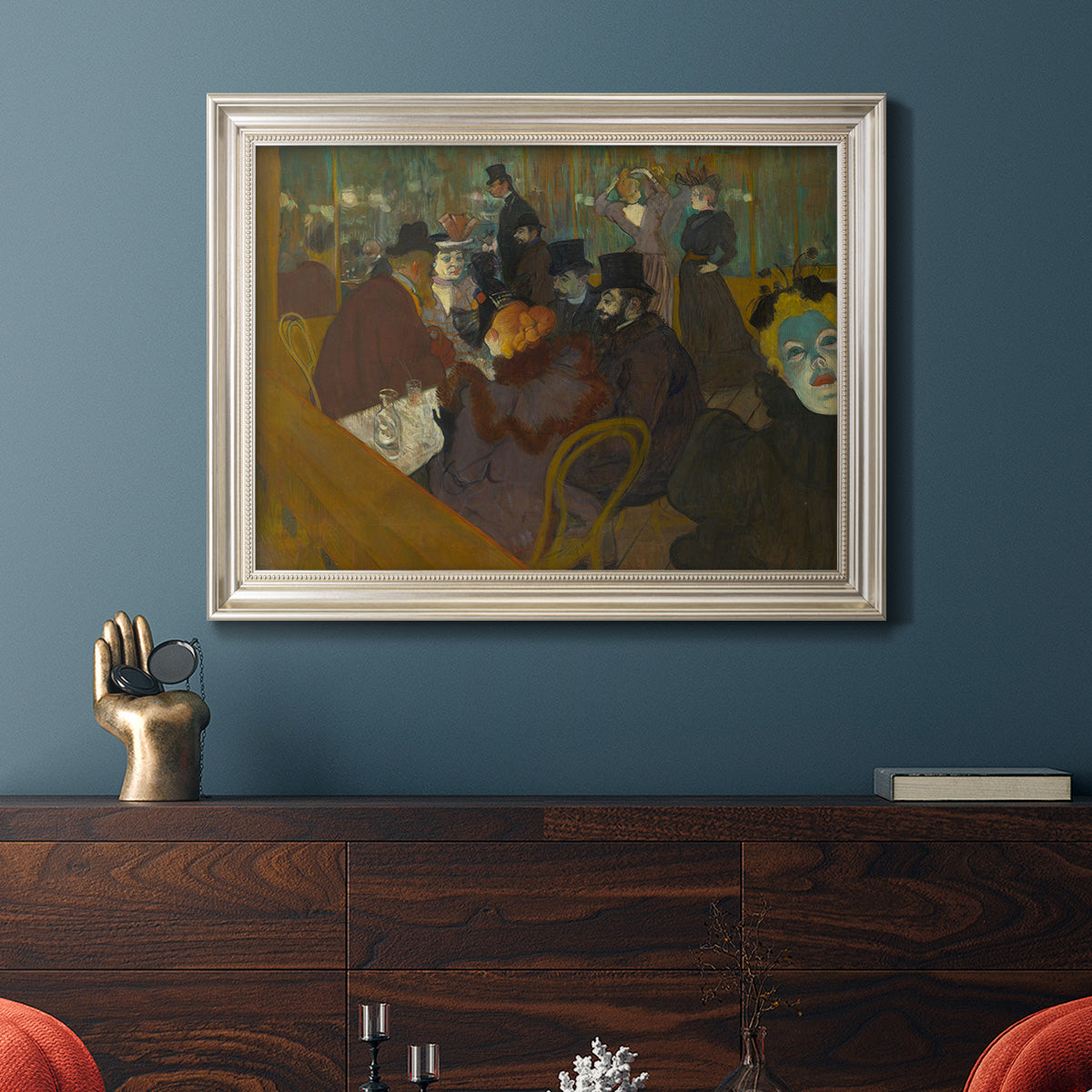 Impressionist cabaret interior scene by Henri de Toulouse-Lautrec in an ornate champagne frame displayed in a light-toned interior setting.