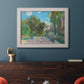 Impressionist residential landscape at Argenteuil by Claude Monet in an ornate weathered white frame displayed in a dark-toned interior setting.