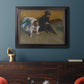 Impressionist portrait of a seated woman by Edgar Degas in an ornate black frame with gilded inner detail displayed in a dark-toned interior setting.