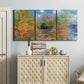 Three-panel canvas wall art featuring wide river landscape, displayed above a cabinet in an entryway.