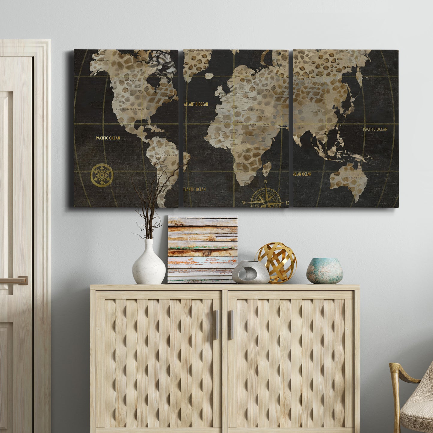 Three-panel canvas wall art featuring illustrated safari world map, displayed above a cabinet in an entryway.
