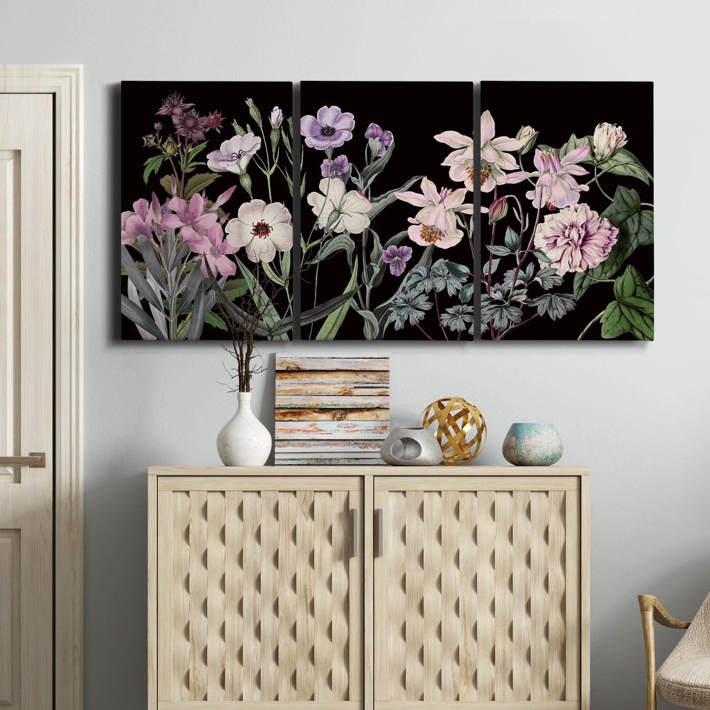 Three-panel canvas wall art featuring early spring blossoms in soft tones, displayed above a cabinet in an entryway.