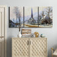 Three-panel canvas wall art featuring snow covered road leading to village, displayed above a cabinet in an entryway.