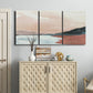 Three-panel canvas wall art featuring quiet coastline with distant horizon, displayed above a cabinet in an entryway.