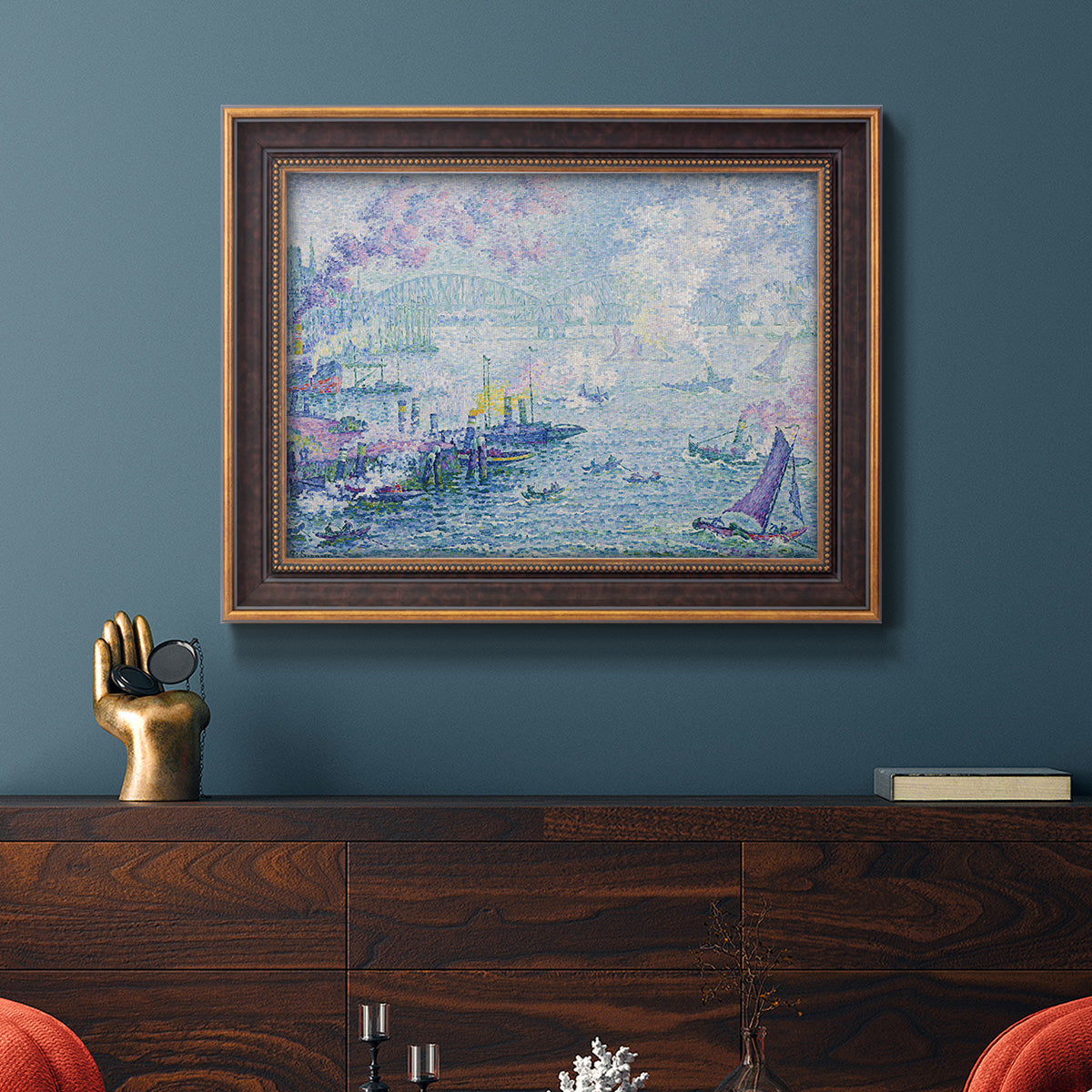 Impressionist industrial harbor scene by Paul Signac in an ornate bronzed mahogany wood frame displayed in a dark-toned interior setting.