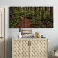 Three-panel canvas wall art featuring forest trail landscape photograph, displayed above a cabinet in an entryway.
