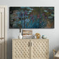 Three-panel canvas wall art featuring water lilies on reflective pond, displayed above a cabinet in an entryway.