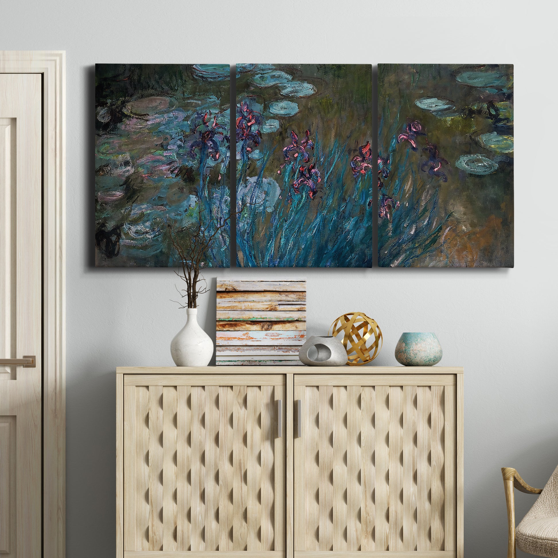 Three-panel canvas wall art featuring water lilies on reflective pond, displayed above a cabinet in an entryway.