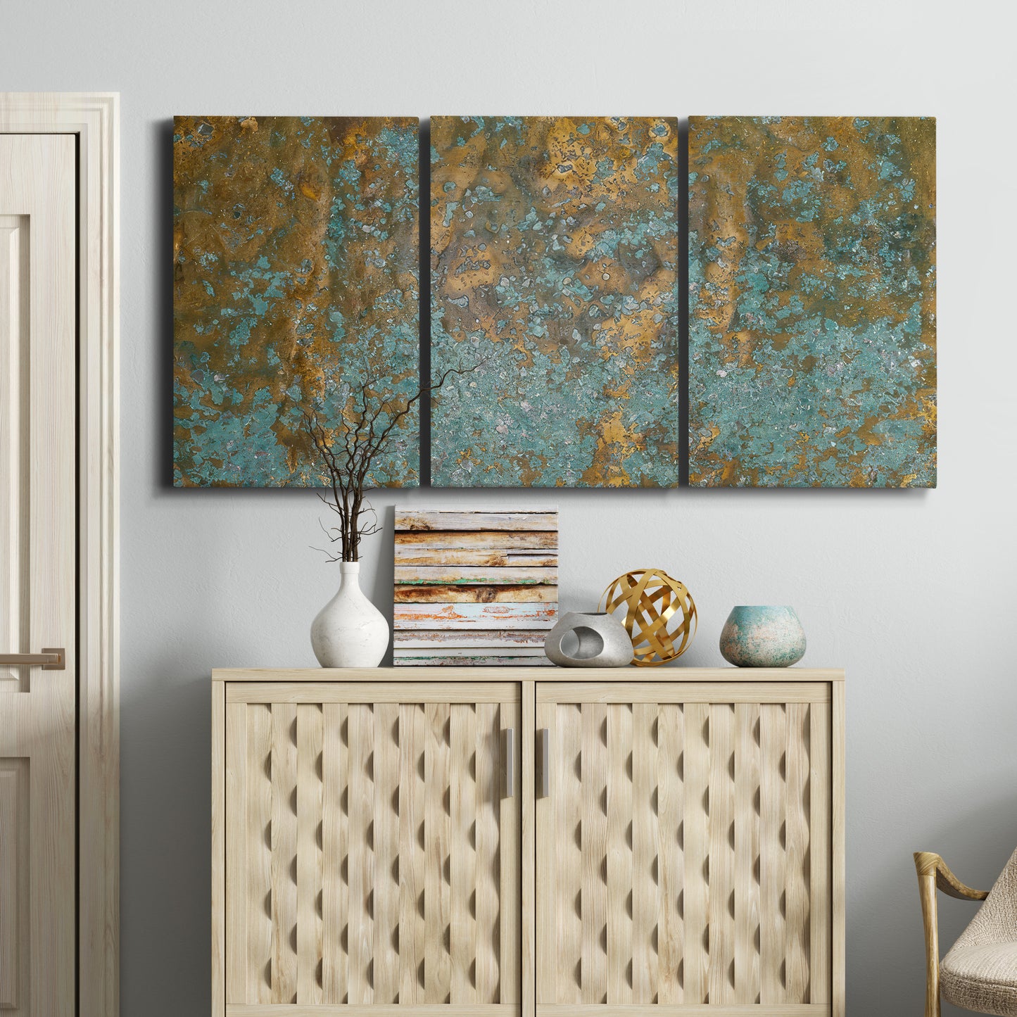 Three-panel canvas wall art featuring earthy copper toned abstract, displayed above a cabinet in an entryway.