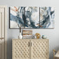 Three-panel canvas wall art featuring repeating abstract geometric array, displayed above a cabinet in an entryway.