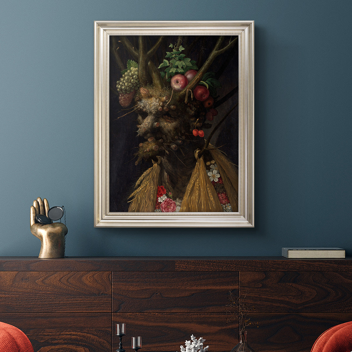 Surreal allegorical portrait representing the four seasons by Giuseppe Arcimboldo in an ornate champagne frame displayed in a dark-toned interior setting.