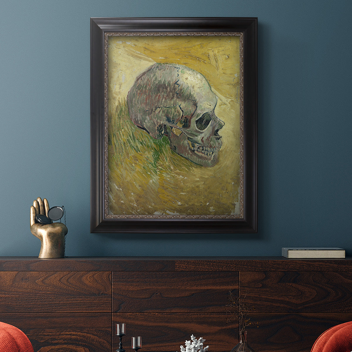 Profile skull study artwork by Vincent van Gogh in an ornate black frame with gilded inner detail displayed in a dark-toned interior setting.