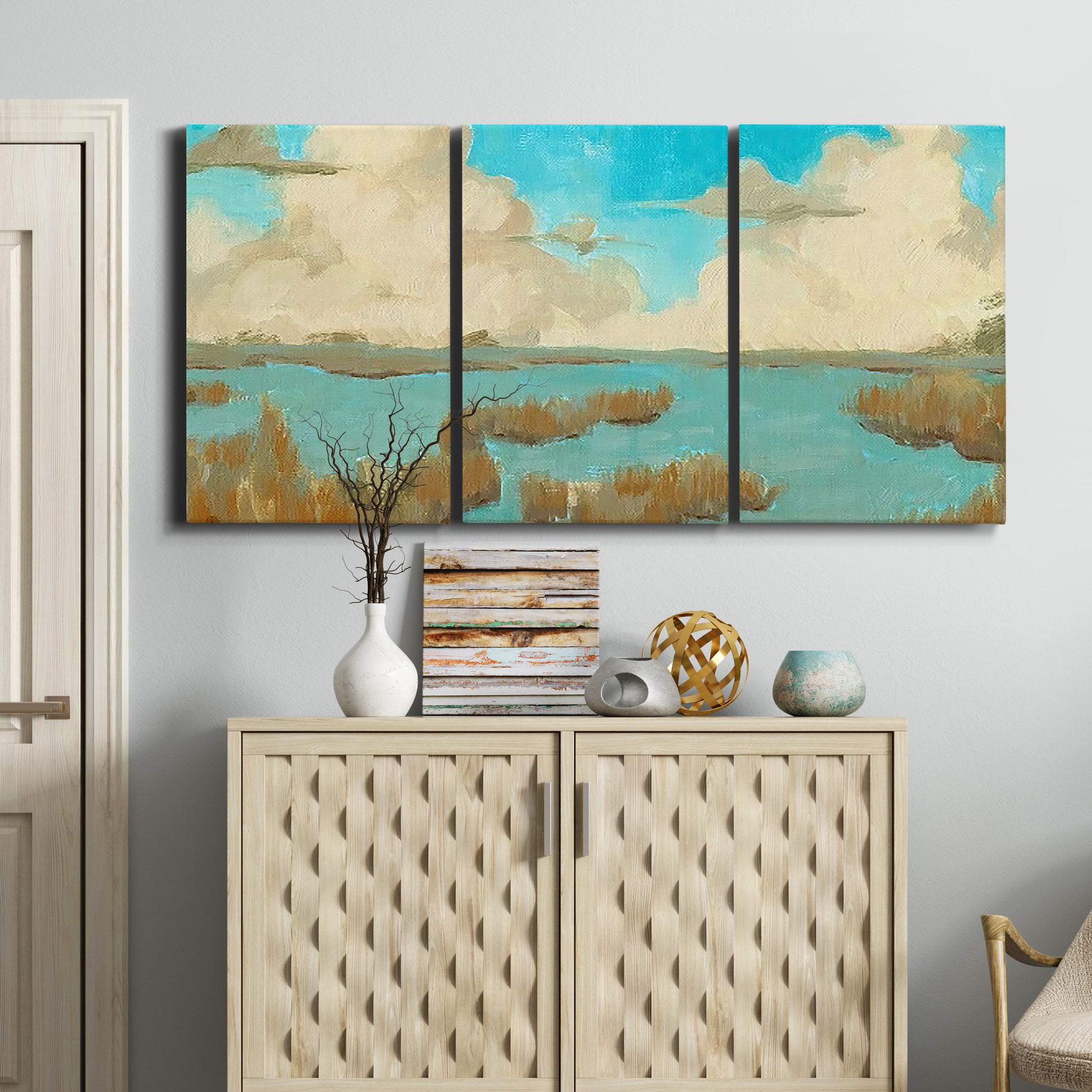 Three-panel canvas wall art featuring abstract pond scene with reflections, displayed above a cabinet in an entryway.