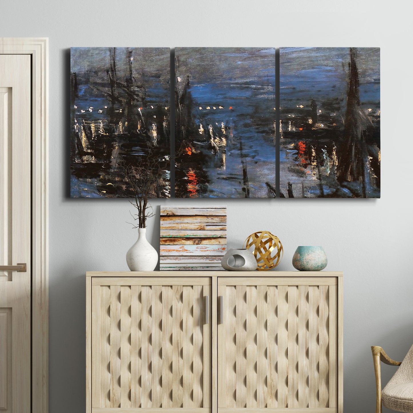 Three-panel canvas wall art featuring Le Havre port at night with lights, displayed above a cabinet in an entryway.
