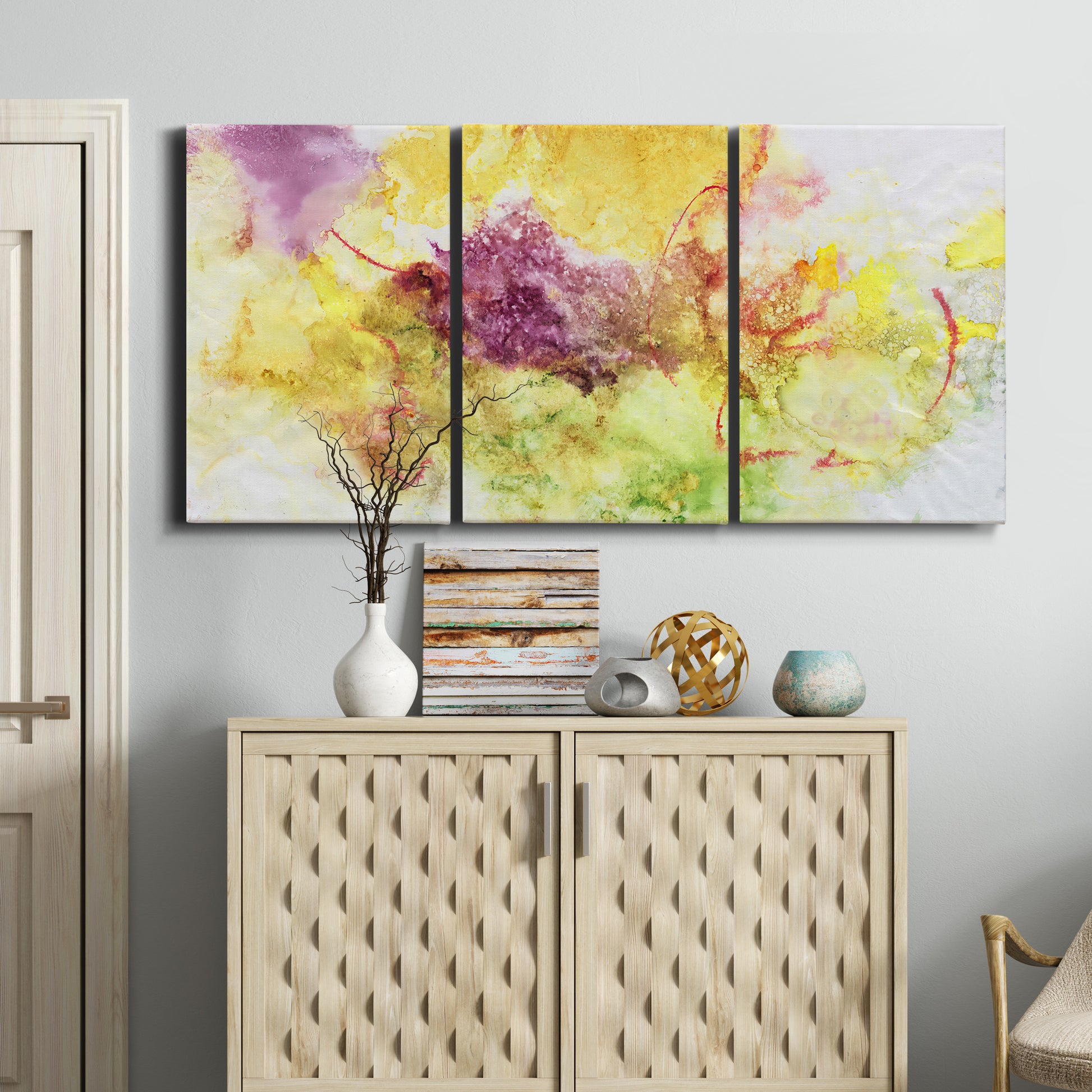 Three-panel canvas wall art featuring abstract floral rhythm composition, displayed above a cabinet in an entryway.
