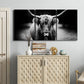 Three-panel canvas wall art featuring black and white cattle portrait, displayed above a cabinet in an entryway.