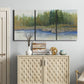 Three-panel canvas wall art featuring riverbank landscape with trees, displayed above a cabinet in an entryway.