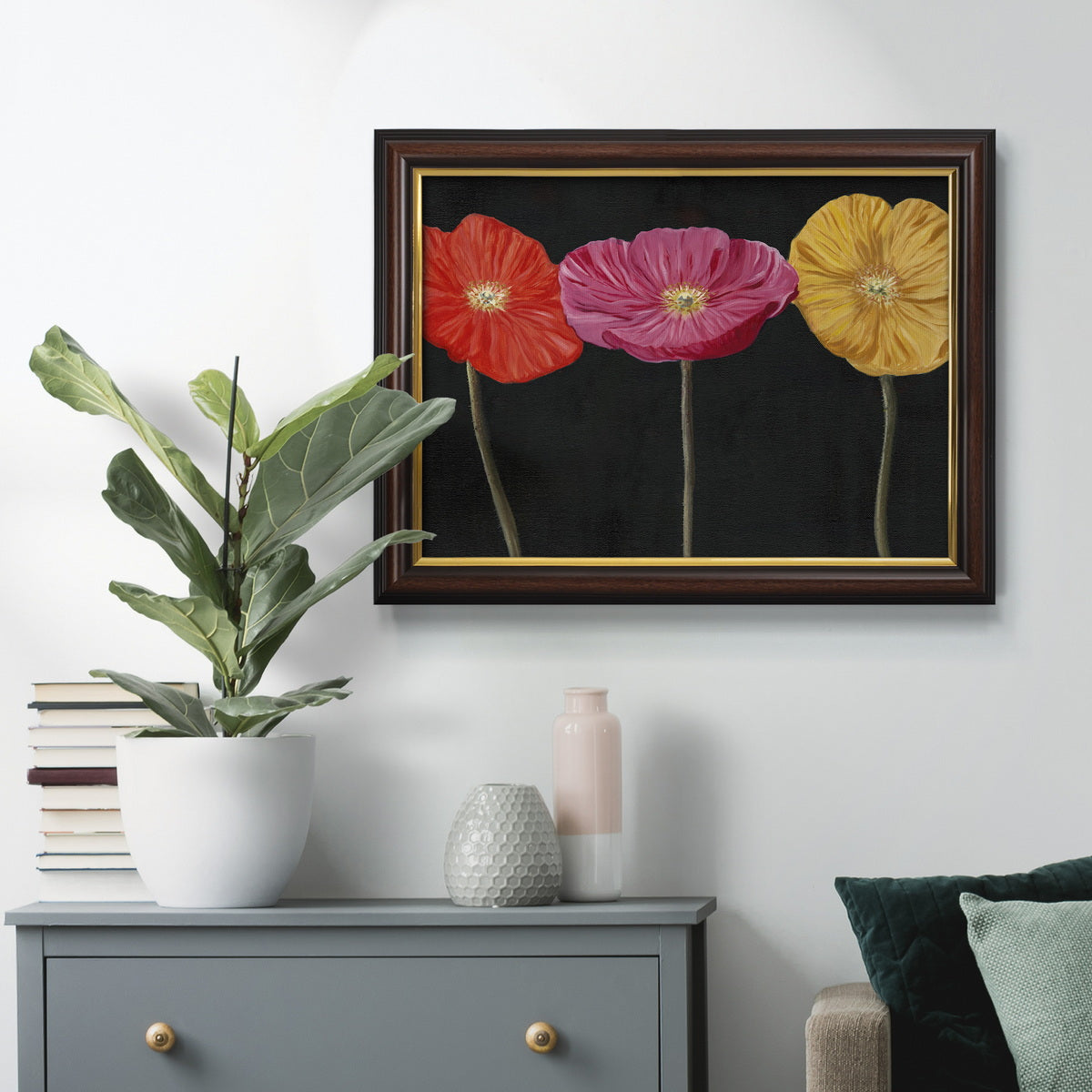 Contemporary poppy flower artwork in an ornate mahogany wood frame with gold liner displayed in a dark-toned interior setting.