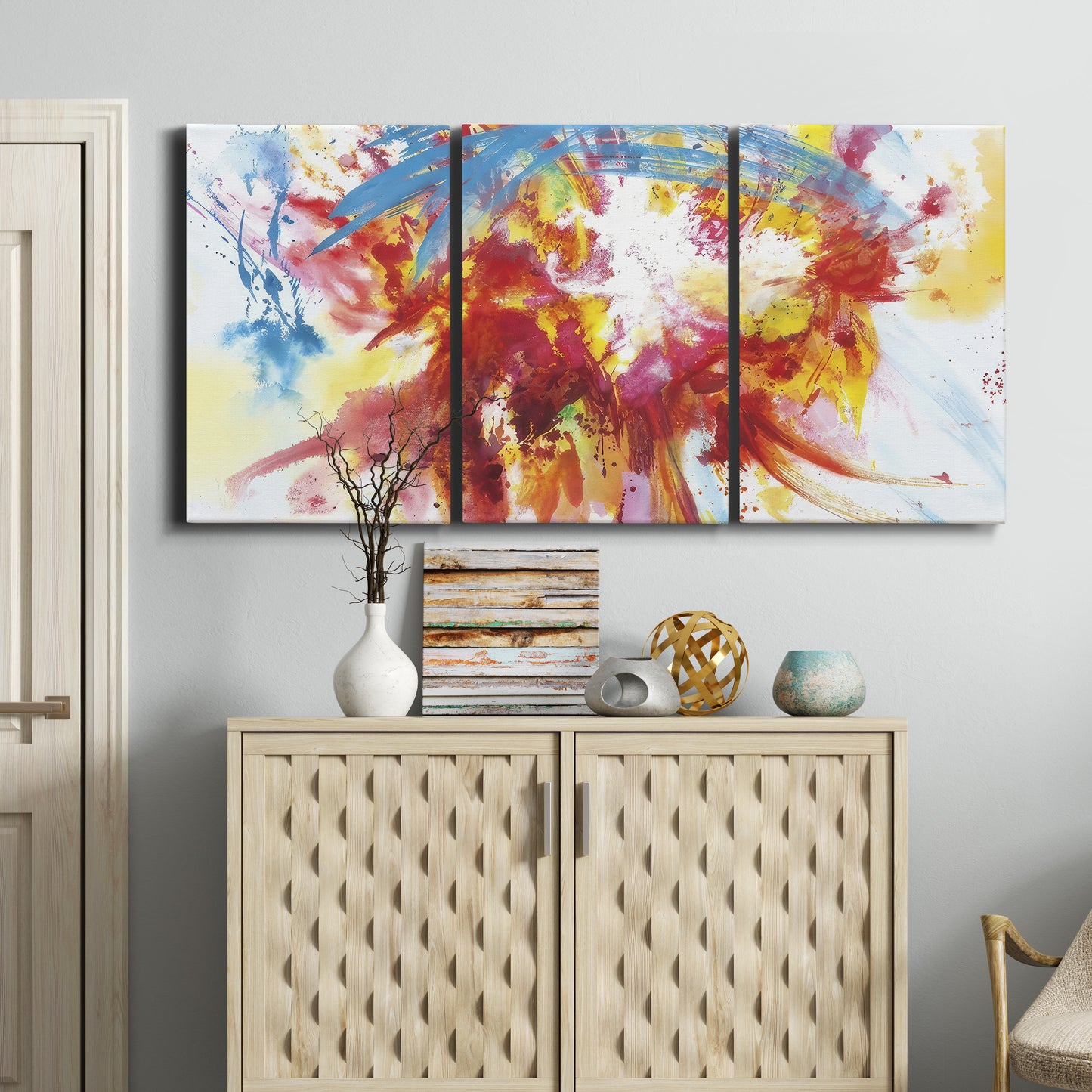 Three-panel canvas wall art featuring bright abstract summer palette, displayed above a cabinet in an entryway.