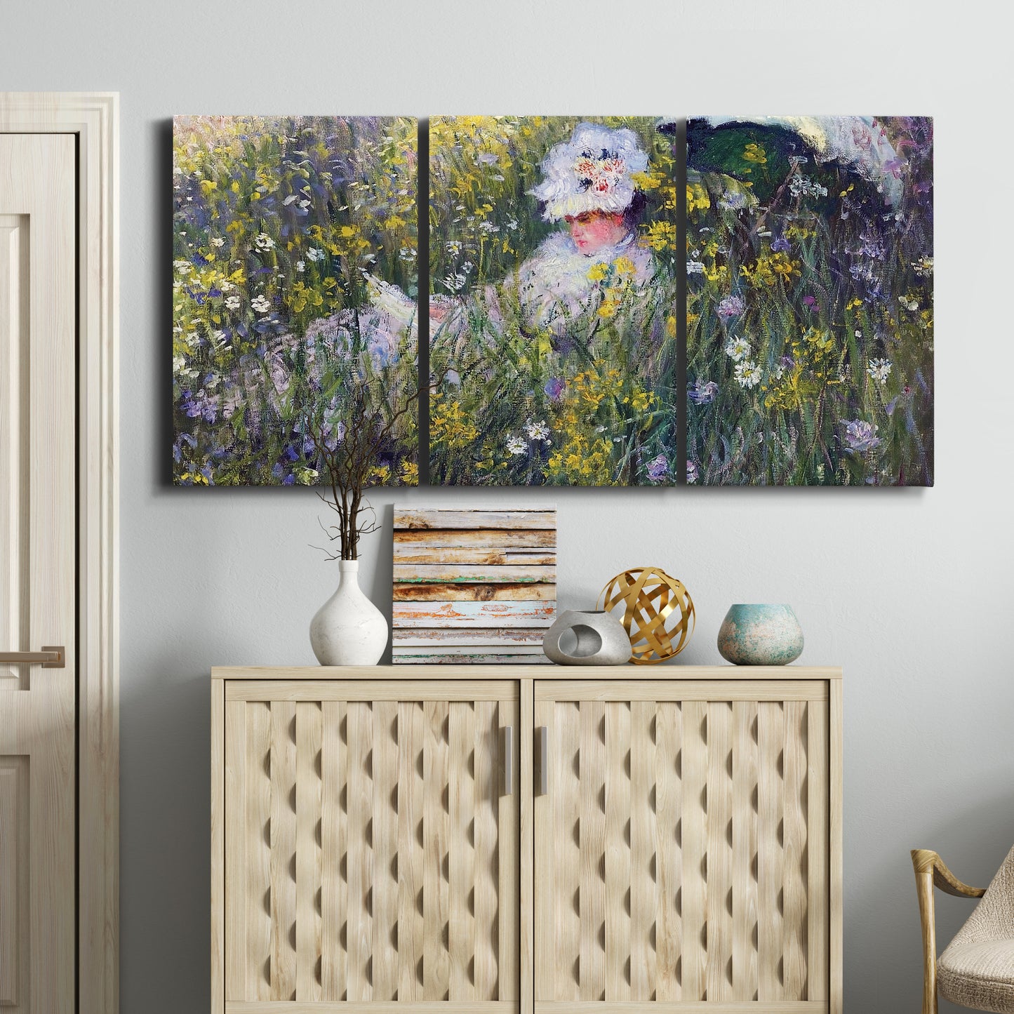 Three-panel canvas wall art featuring woman walking with parasol, displayed above a cabinet in an entryway.