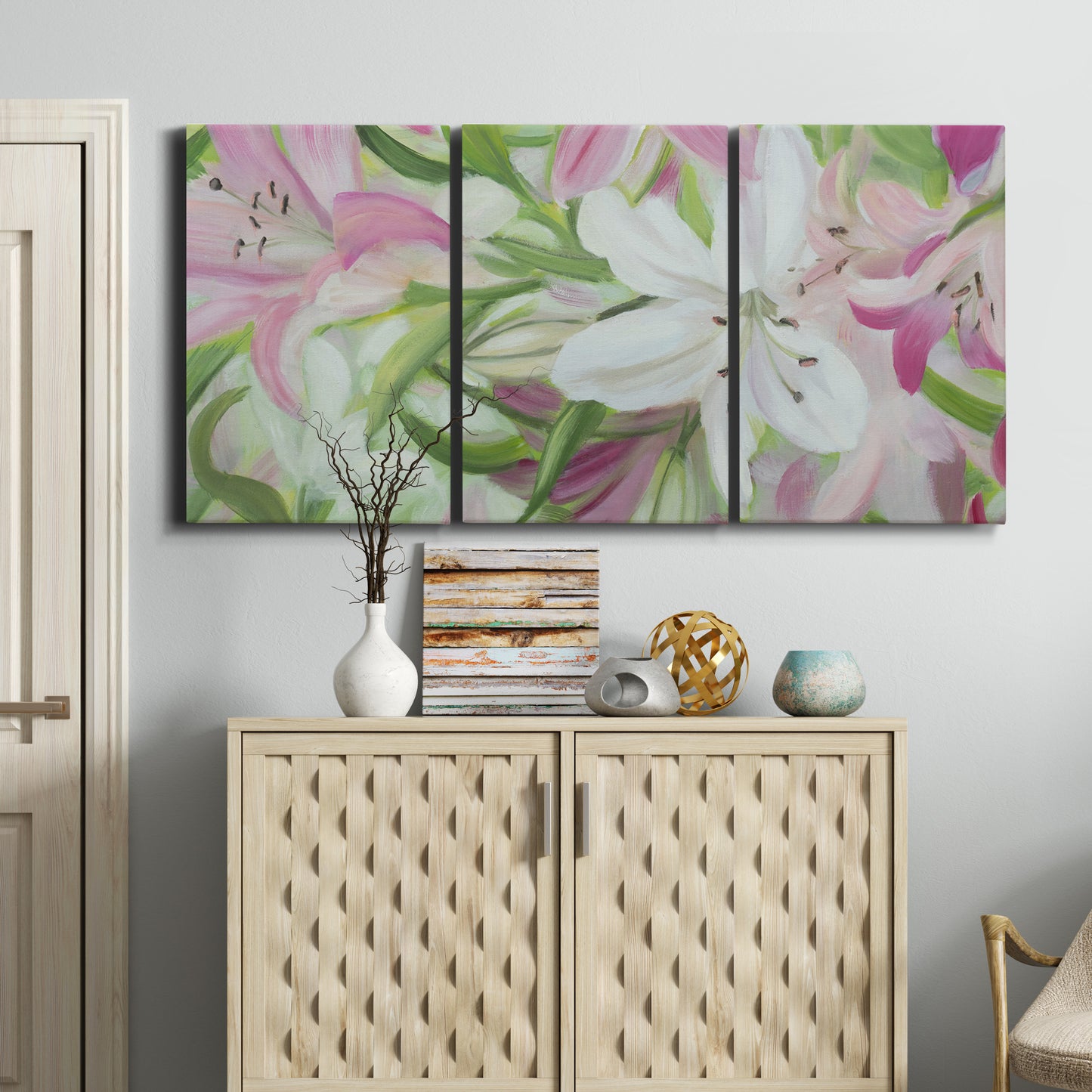 Three-panel canvas wall art featuring pink and white lilies botanical study, displayed above a cabinet in an entryway.