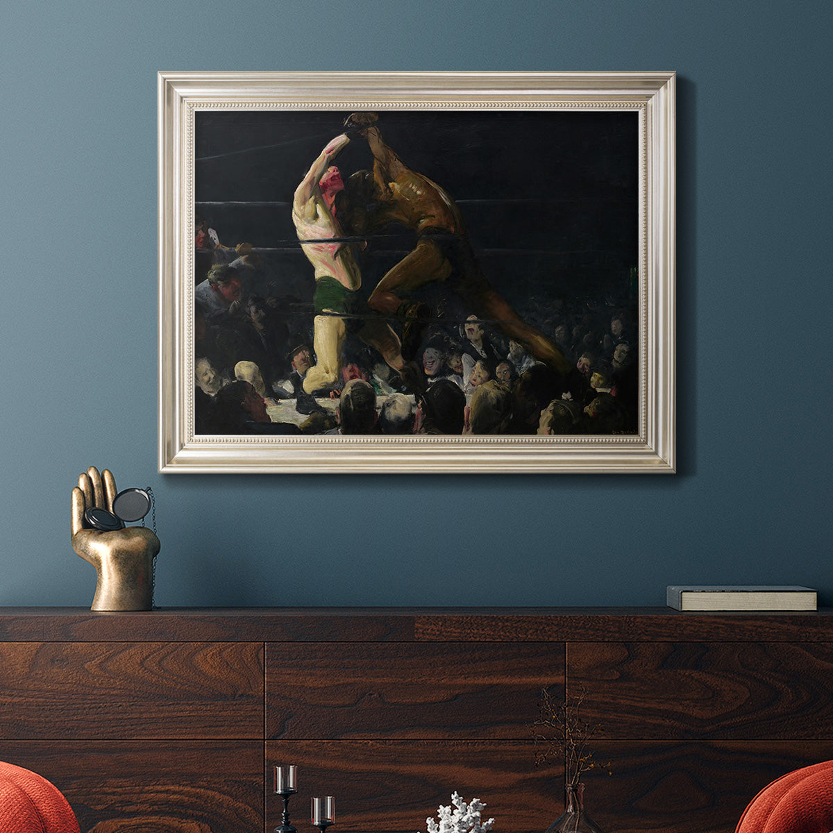 American genre painting of men in a social club by George Bellows in an ornate champagne frame displayed in a dark-toned interior setting.