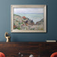 Impressionist coastal watch cabin scene by Claude Monet in an ornate champagne frame displayed in a dark-toned interior setting.