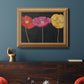 Contemporary poppy flower artwork in an ornate antique gold frame displayed in a dark-toned interior setting.