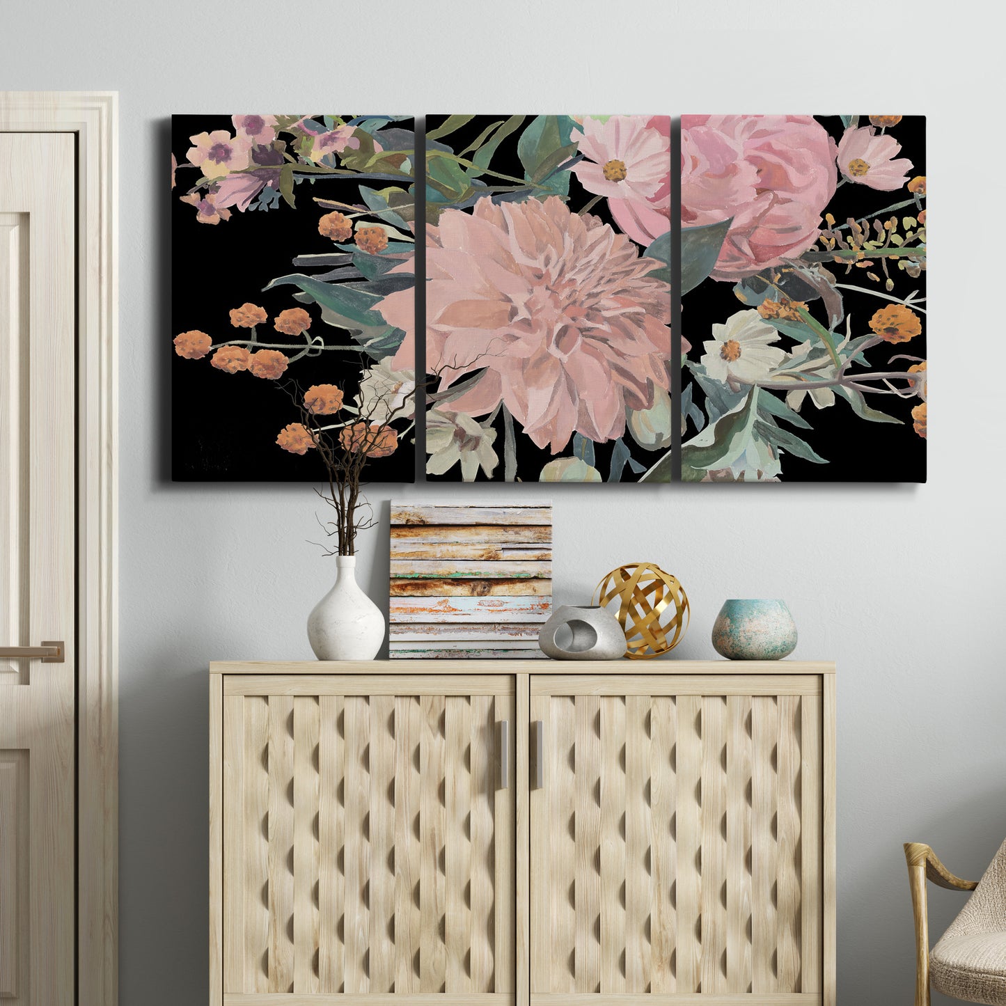 Three-panel canvas wall art featuring dark floral night blossoms, displayed above a cabinet in an entryway.